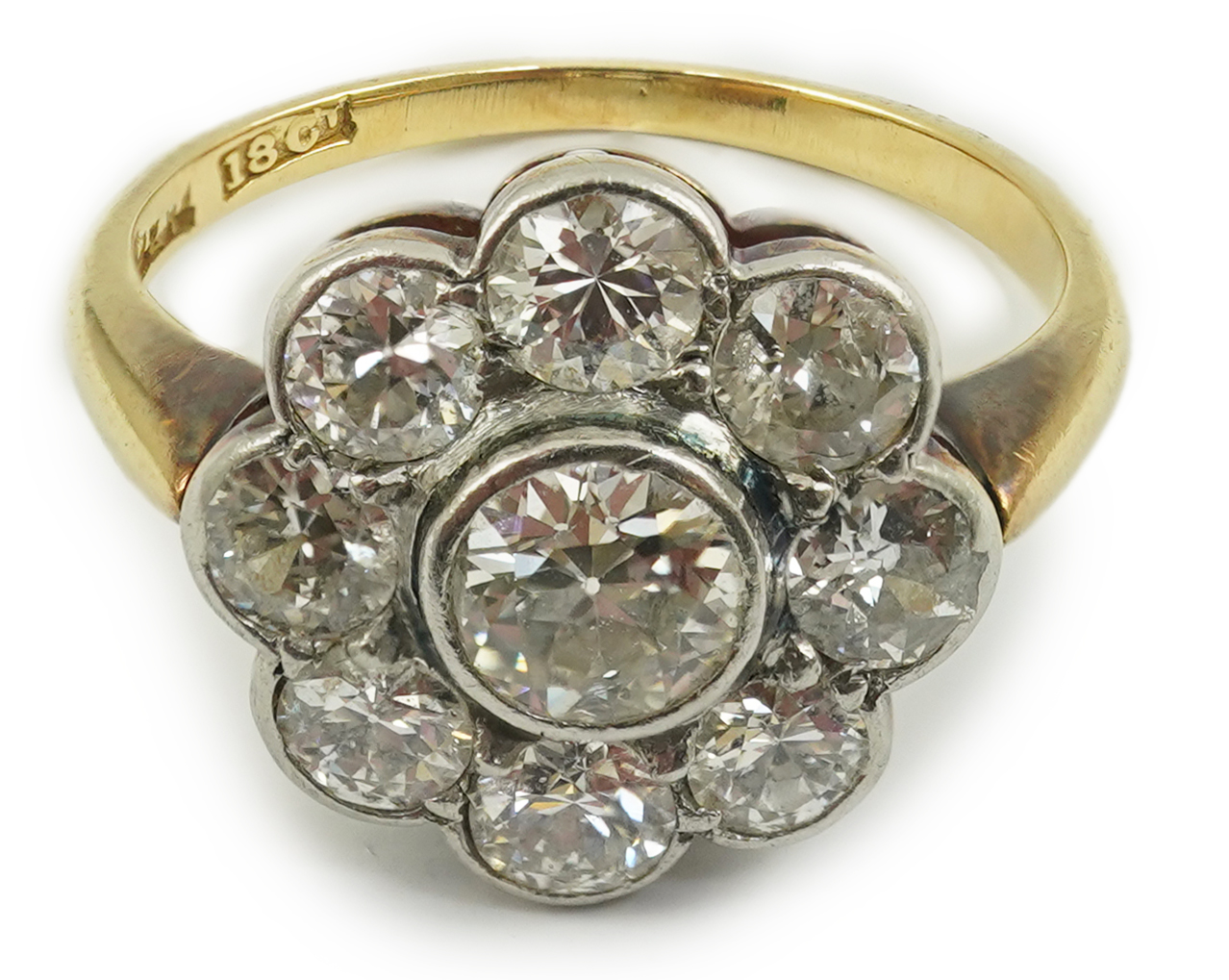 A mid 20th century 18ct gold and nine stone diamond set flower head cluster ring